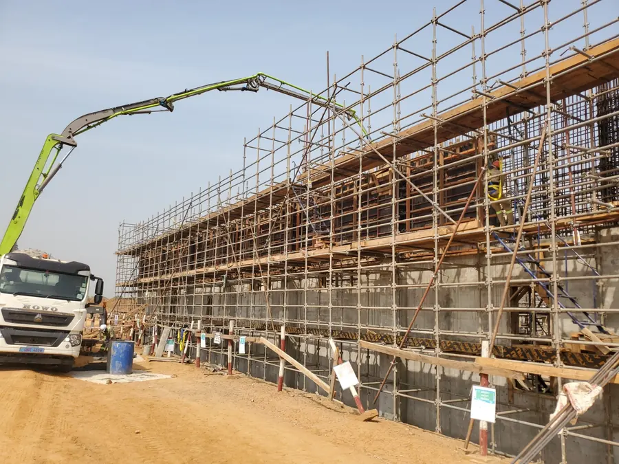 Concrete construction works with scaffolding and pump equipment