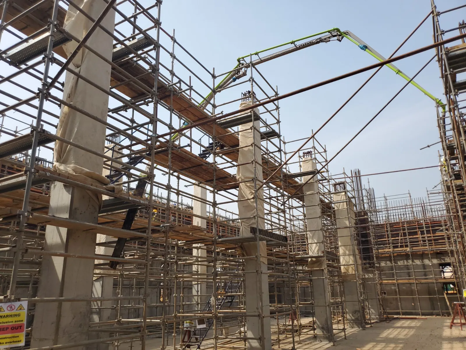 Structural construction site with scaffolding and concrete columns